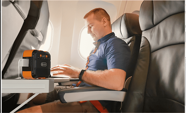 Illustrative FlashFish A101 beside an aircraft passenger; airline permission and onboard-use rules still require confirmation