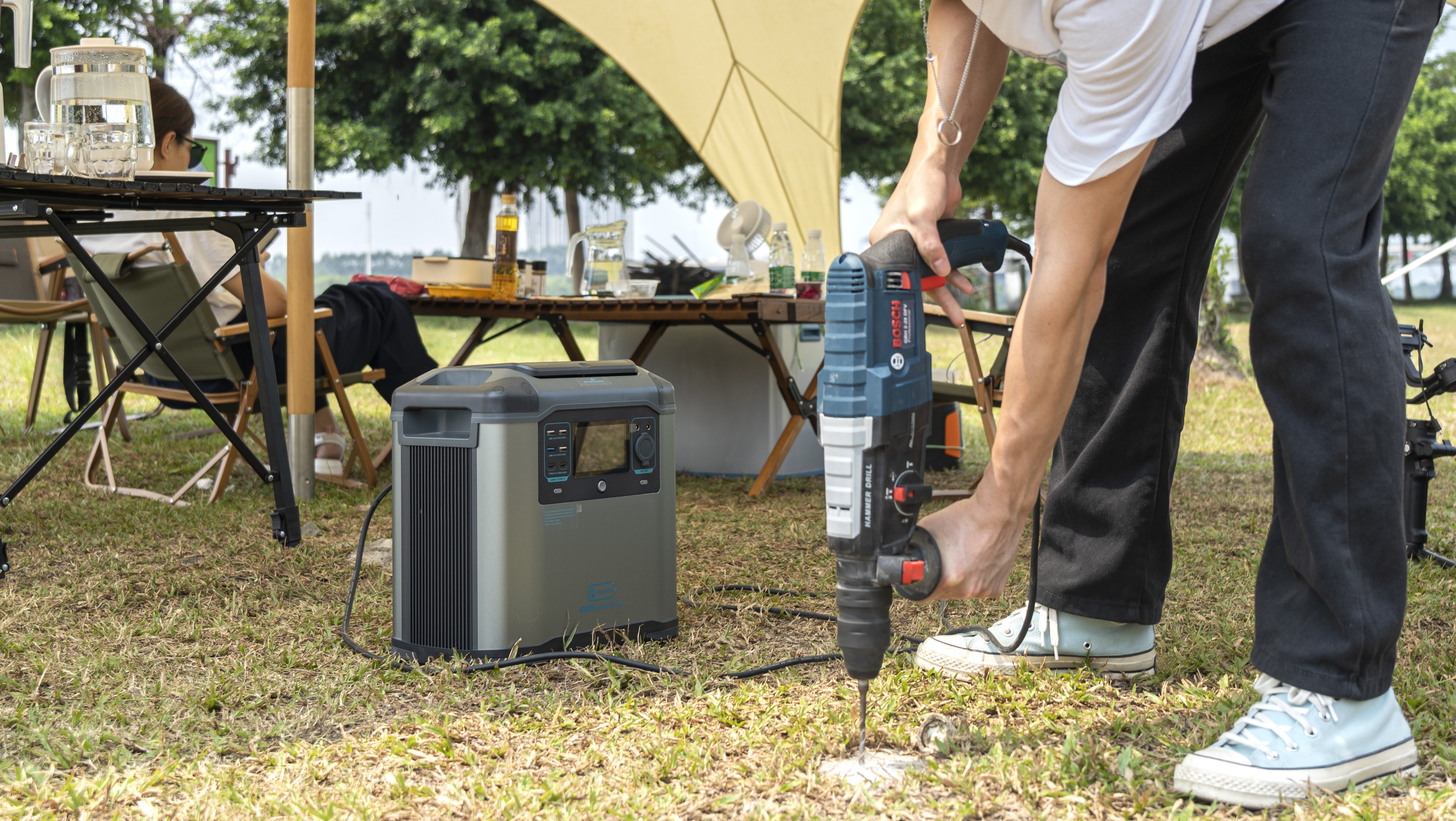 FlashFish portable power station supporting a campsite tool setup